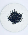 Loose-leaf Hian Di Zai Twin Orchid Aroma DanCong Oolong, showcasing twisted high-mountain Phoenix DanCong tea leaves.