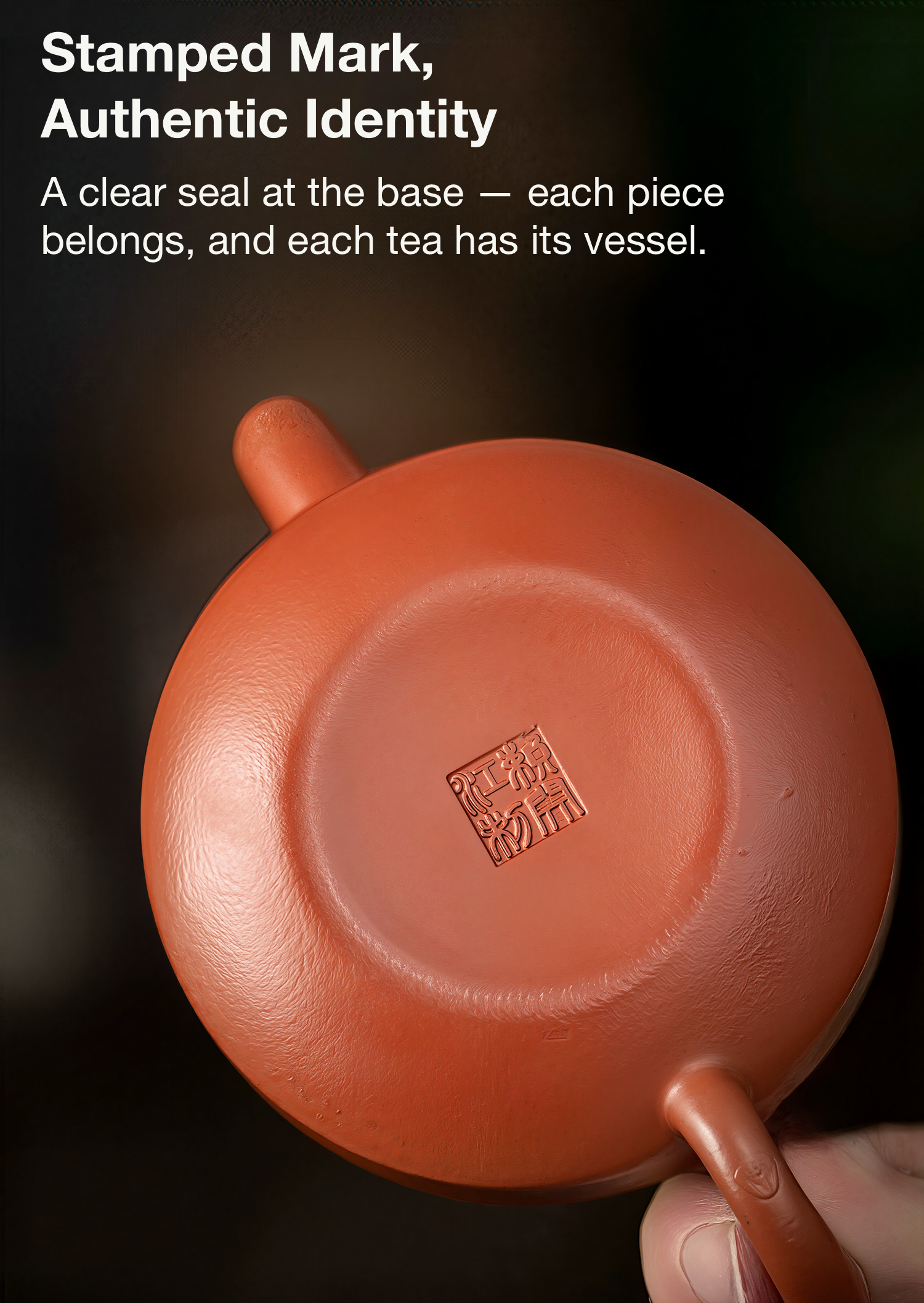 Red ceramic teapot with a clear seal at the base on a dark background