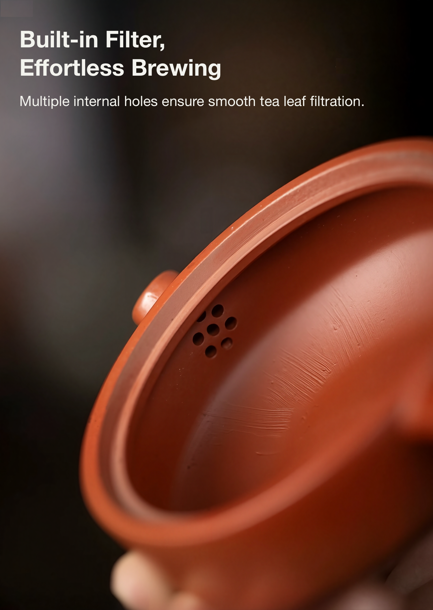 Red ceramic teapot with text about built-in filter and effortless brewing.