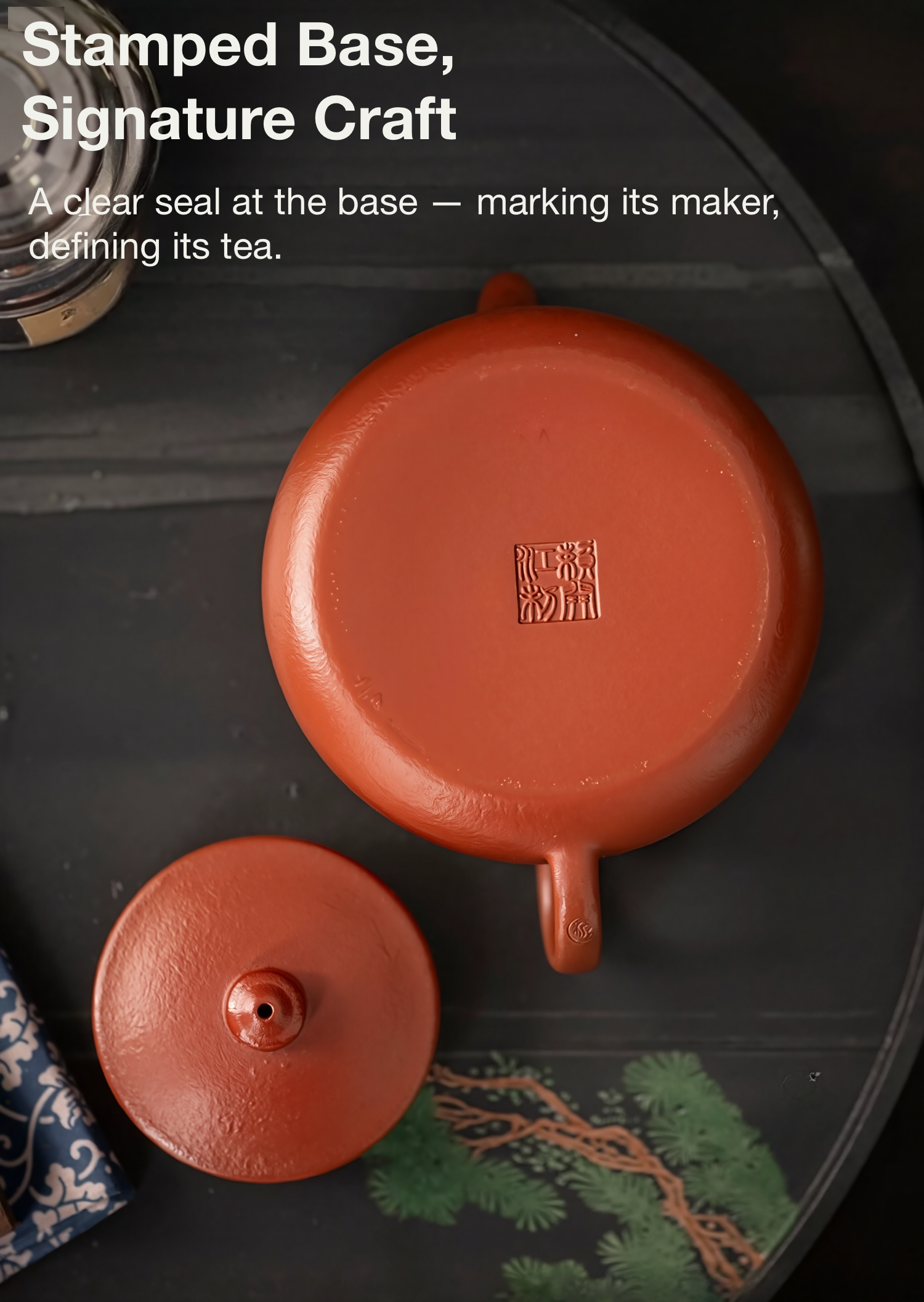 Red teapot with a stamp on the base on a dark surface