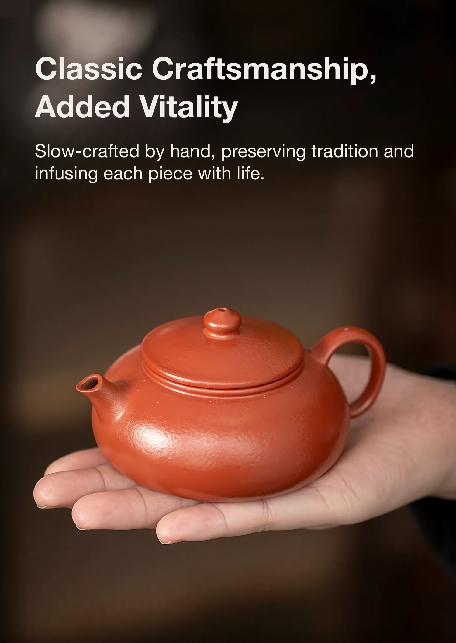 Red ceramic teapot held in a hand with text about craftsmanship and tradition.