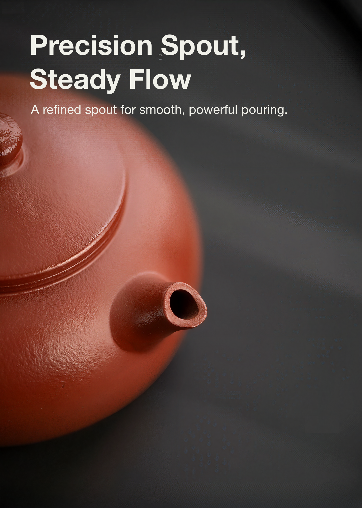 Red teapot with precision spout on a dark background