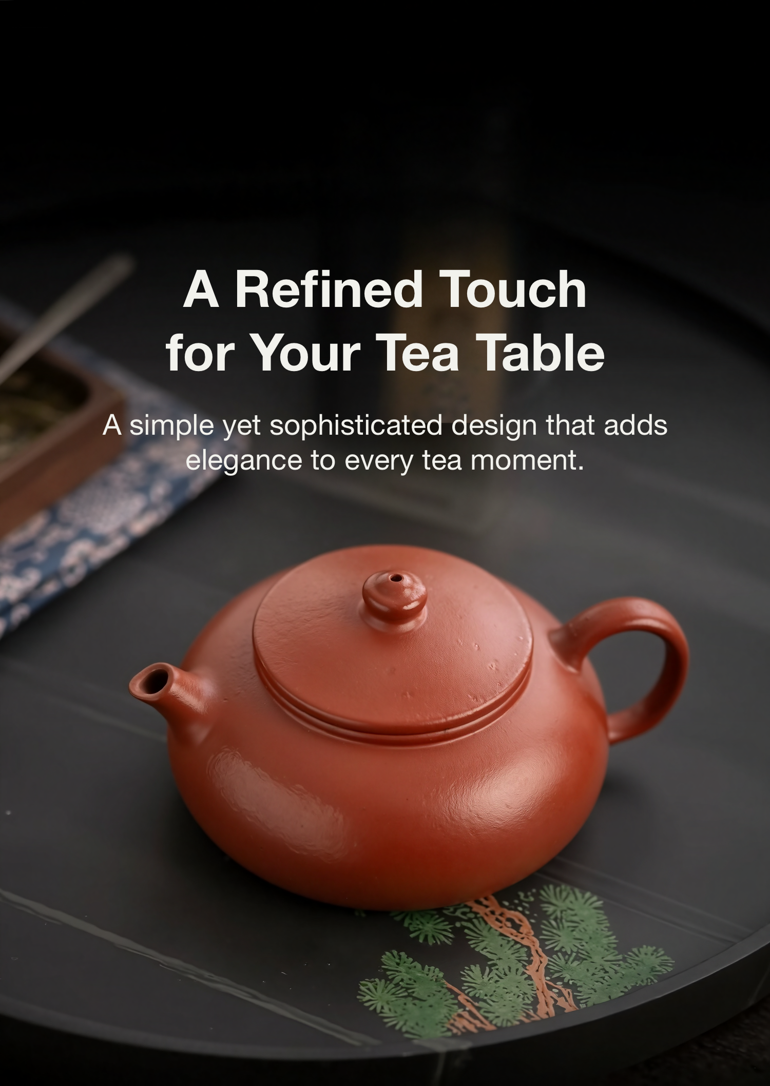Red ceramic teapot on a dark surface with text about its design.