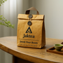 Jaktea reusable kraft paper tea tote with logo, eco-friendly insulated bag on wooden table.
