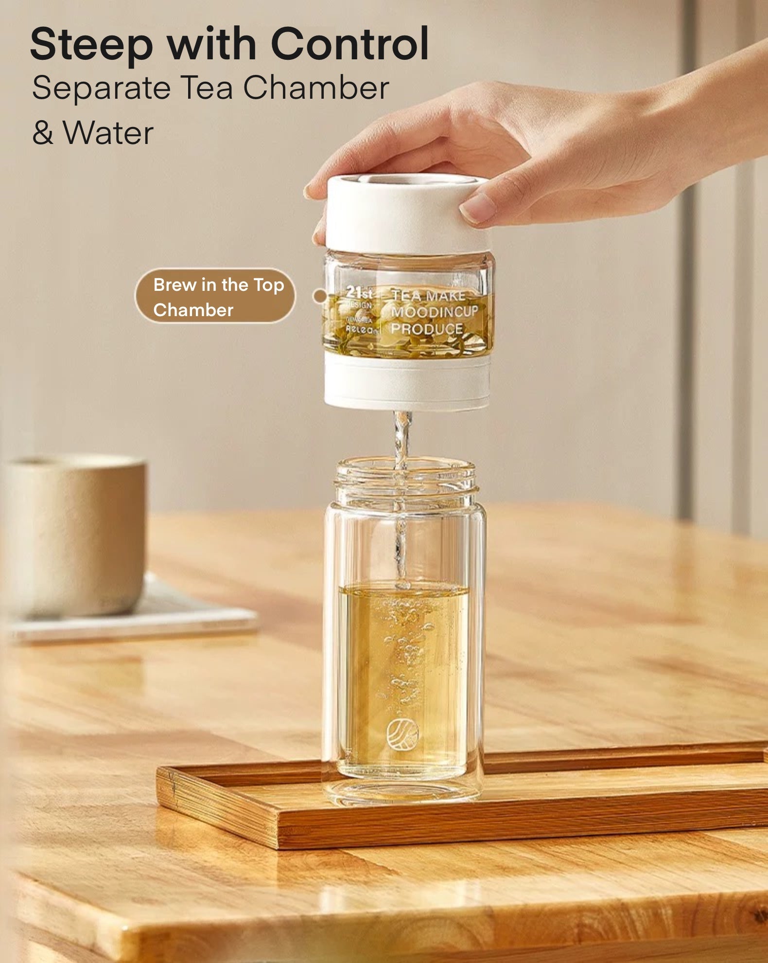 Tea-making device with a hand pouring liquid into it on a wooden surface.