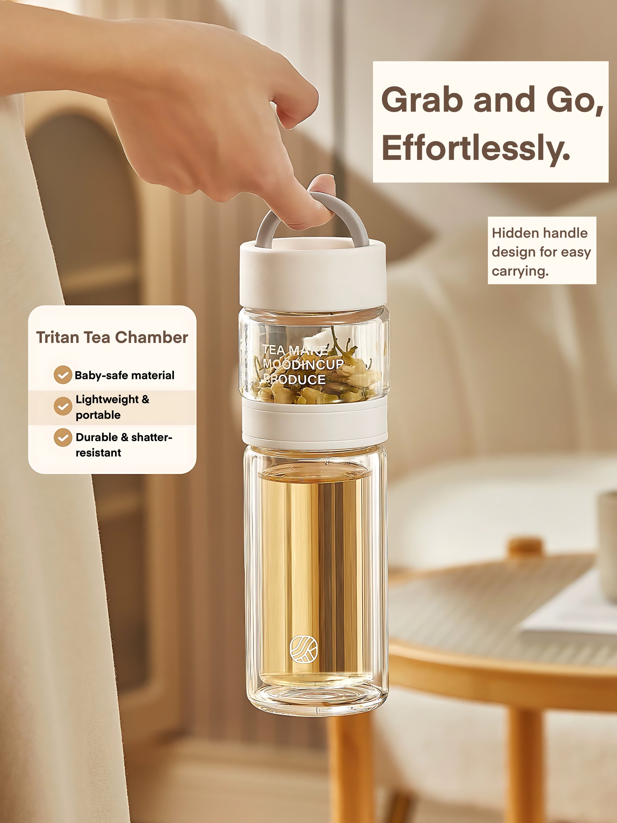 Clear tea infuser bottle with white handle held by a hand, set against a neutral background.