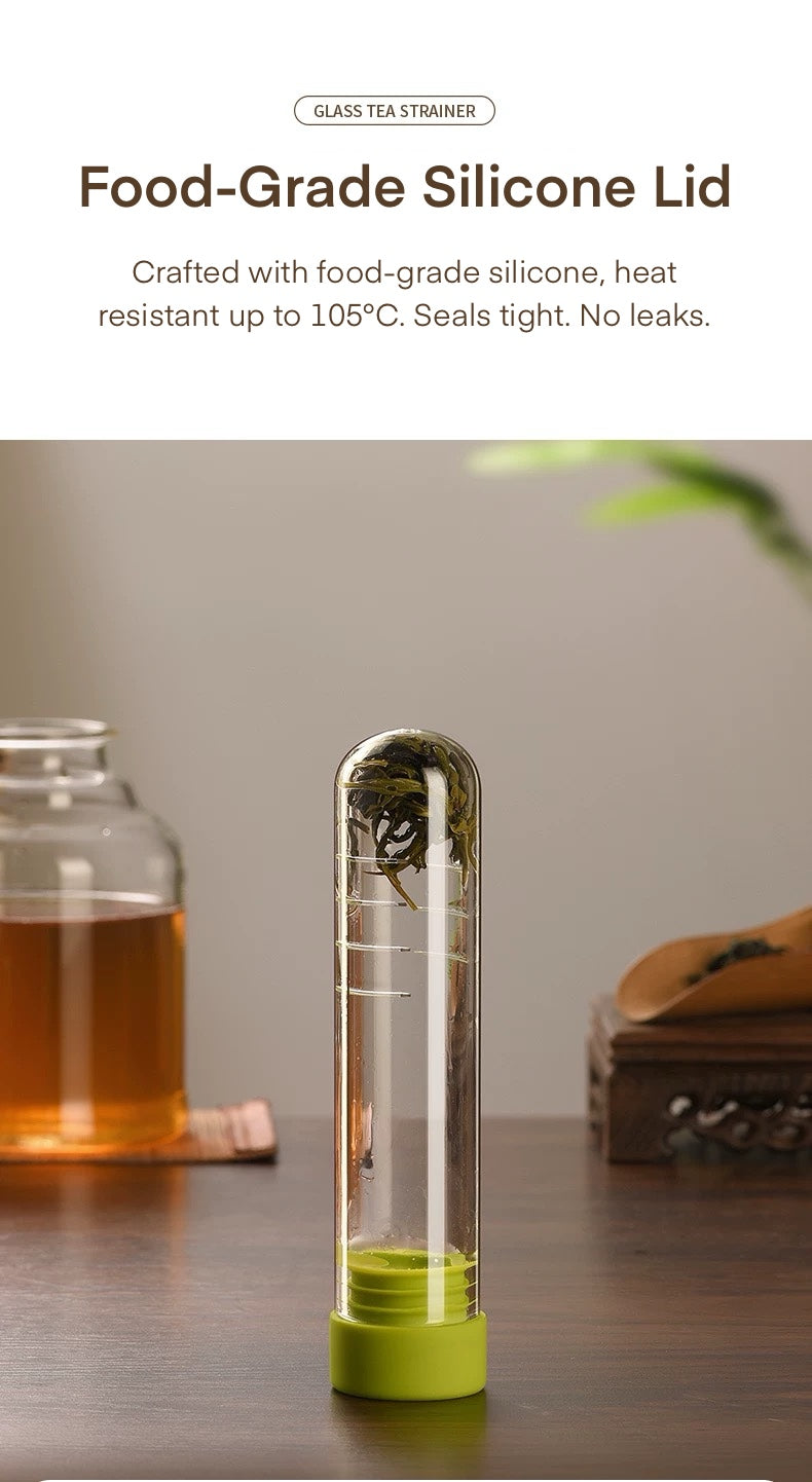 Food-grade silicone lid with a glass tea strainer on a wooden surface.