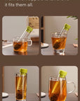Tea infuser in use with different types of cups on a table.